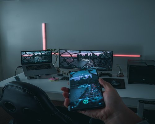 Smartphone displaying a fictional mobile game at an Australian gaming technology exhibition